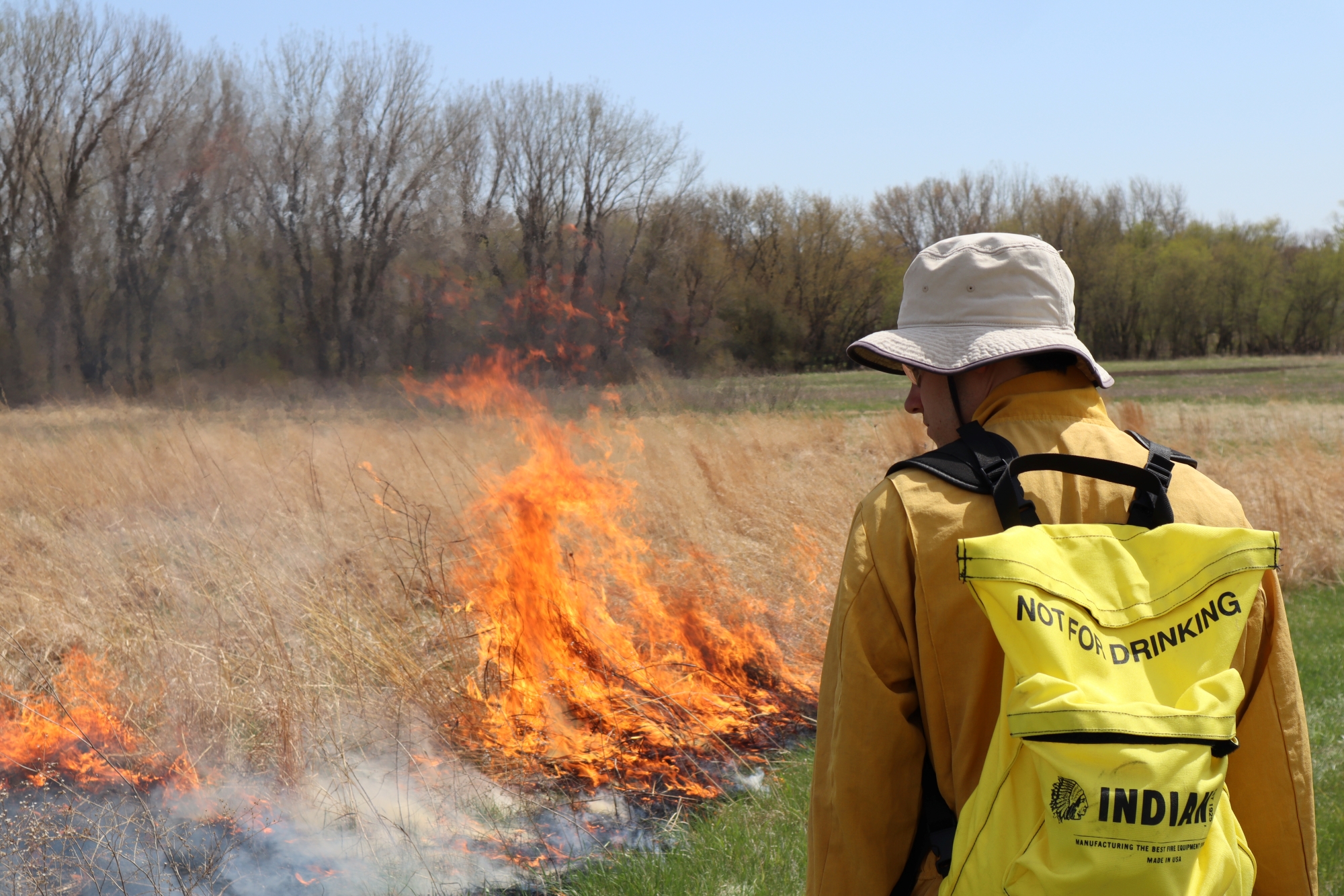 Student helping with prairie burn