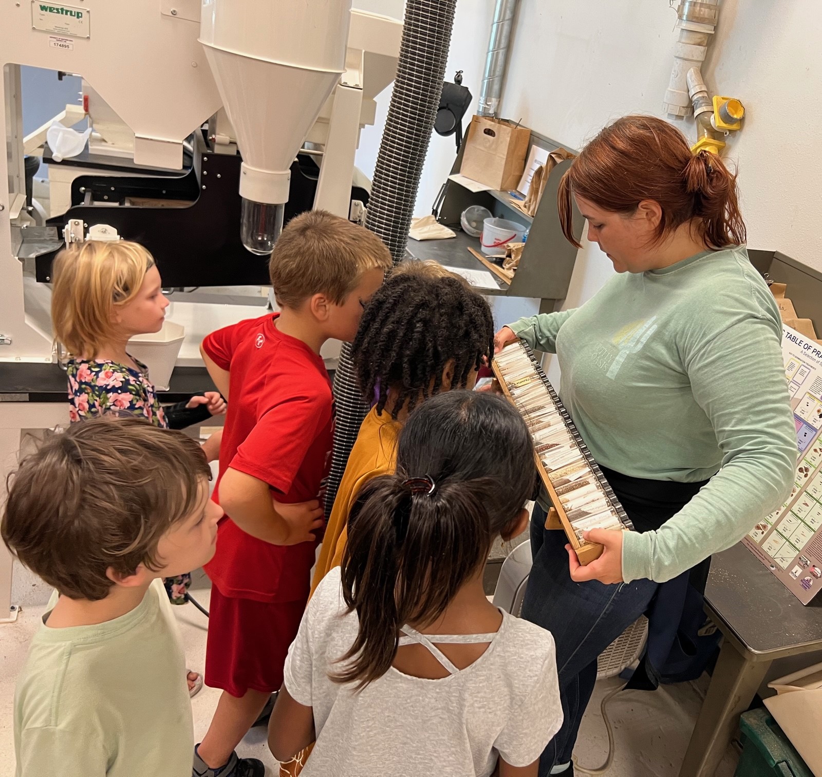 Young students looking at seeds in the TPC's seed cleaning lab